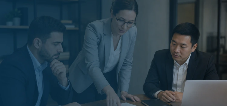 Financial experts reviewing charts and business performance during a quality of earnings analysis meeting.