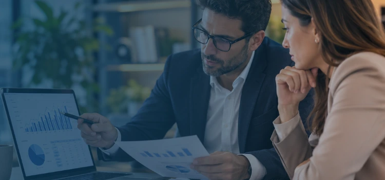 Financial consultants reviewing quality of earnings data, cash flow charts, and business performance reports in a modern office.