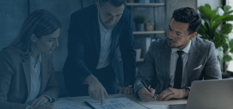 Professional accounting and franchise consultants reviewing financial charts and reports during a business advisory meeting in a modern office.