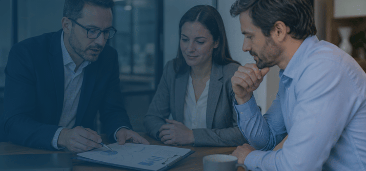 Franchise consultant reviewing financial reports with business owners during a professional office meeting