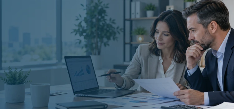 Payroll accounting professionals reviewing payroll reports, financial records, and reconciliation data in a modern office.